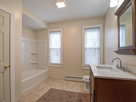 bathroom with tub. Laundry in closet.