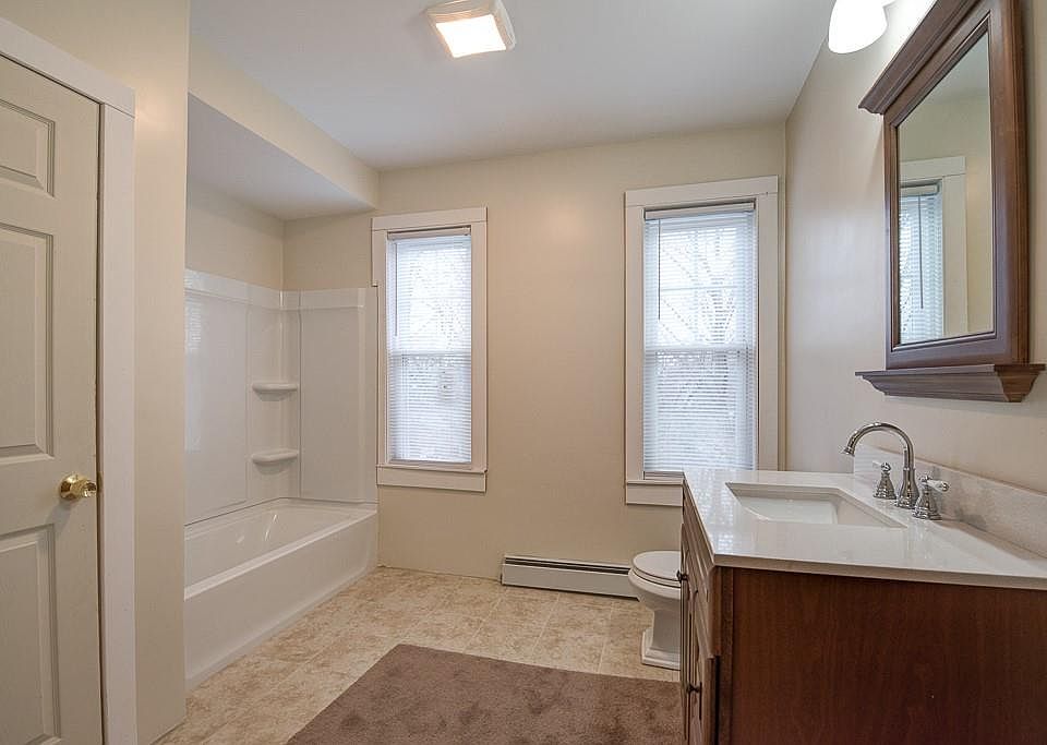 bathroom with tub. Laundry in closet.