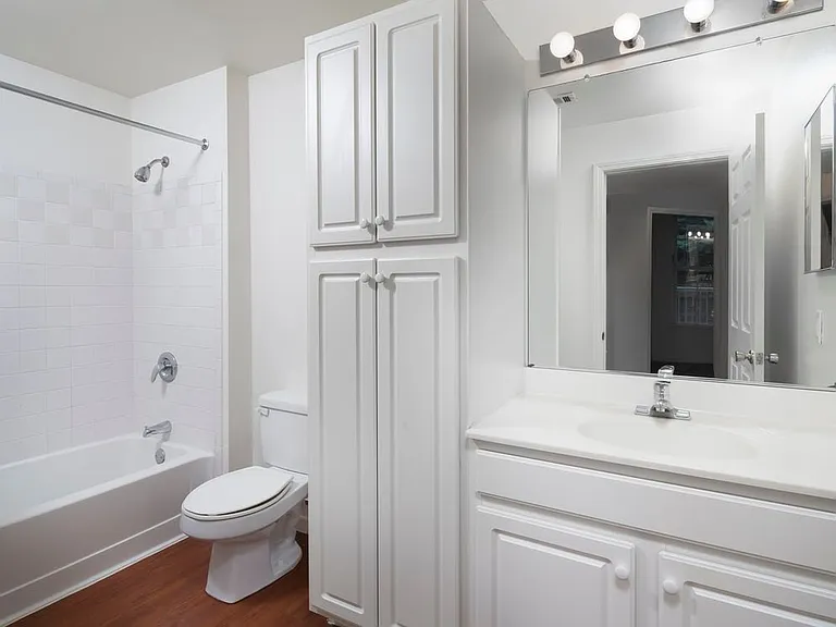 Wilmington West Classic Package bath with white or beige laminate countertops, white cabinetry, and hard surface flooring