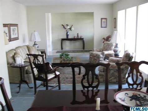 Formal Living room boast 3 large windows covered with Hunter Douglas 'Sillouettes" for an elegant look