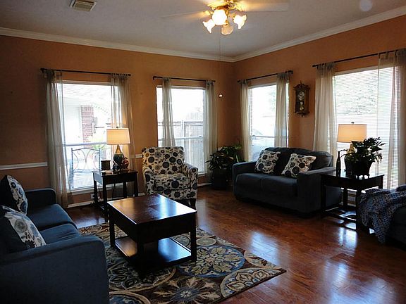 Centrally located family room has a wall of glass windows, plus the warmth of a fireplace.