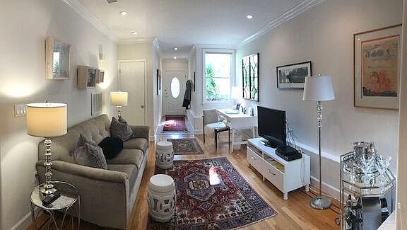 Living room set up with TV and desk area.