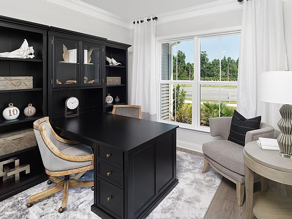 Flexible living space shown as a home office with hardwood floors. - Model Representation