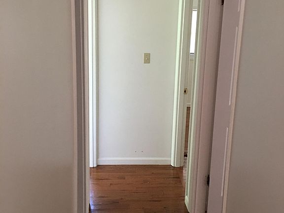 Hallway. 1st left is bathroom, 2nd left is bedroom 1. 2 doors on right lead to other bedrooms.