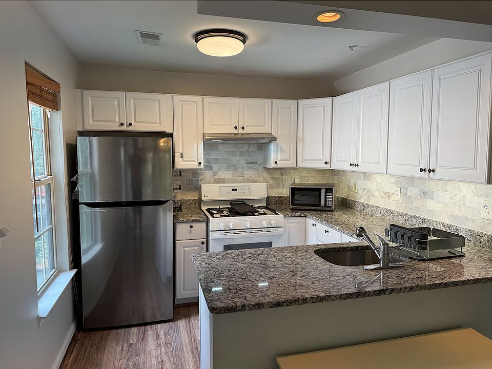 Updated kitchen - featuring brand new marble backsplash, granite countertops and white painted cabinet. 2024 new stainless steel refrigerator and 2024 new range hood, gas stove, oven