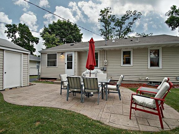 Huge flagstone patio off the kitchen overlooks the   private fenced yard.