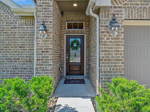 Beautiful and energy efficient glass front door with combination lock. The home also has gutters on all 4 sides.