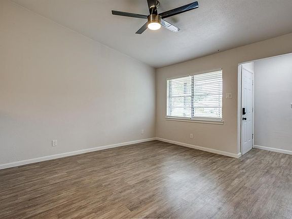 Empty room featuring wood finished floors and ceiling fan