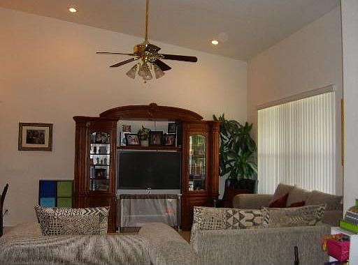 Large family room with huge window and volume ceilings.
