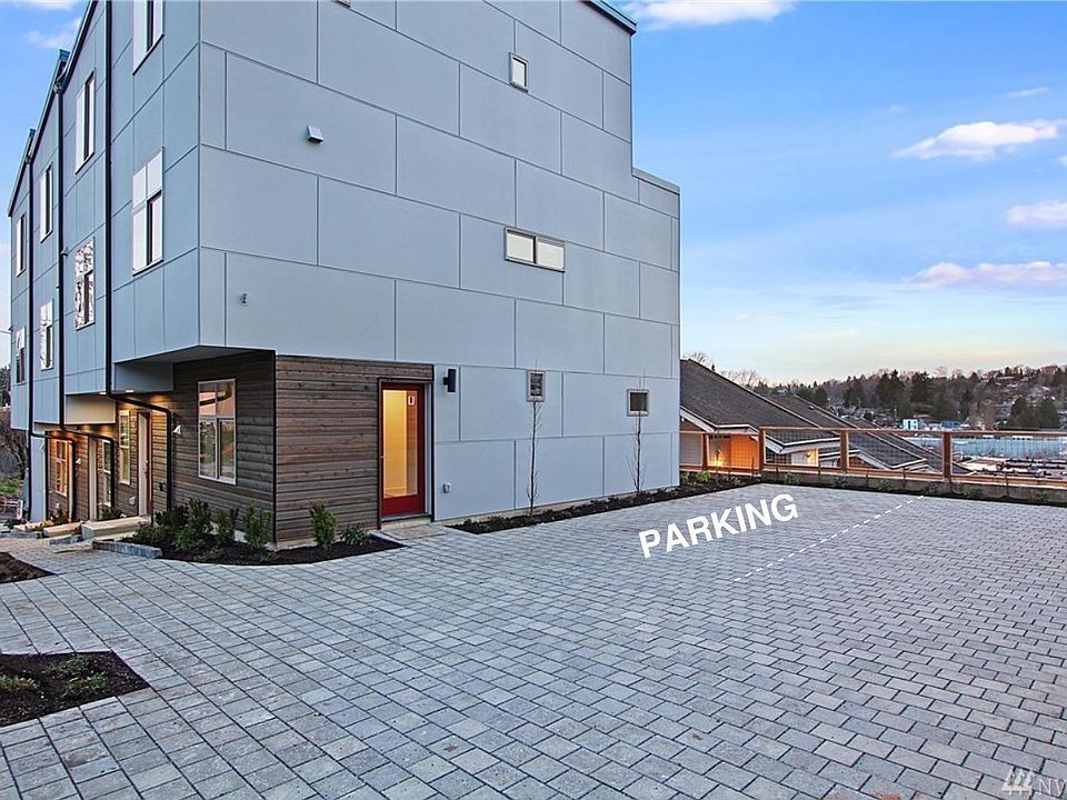 Exterior with designated parking next to the townhome