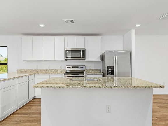 The kitchen is chef-ready with stainless steel appliances