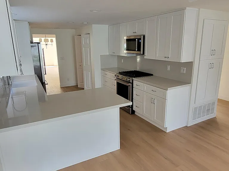All new kitchen with new Kitchen Aid appliances, with all new cabinets, new sink, laundry room and over sized refrigerator.