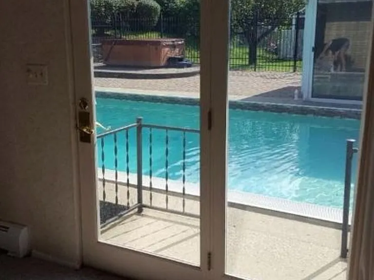 Master bedroom with door to pool area.