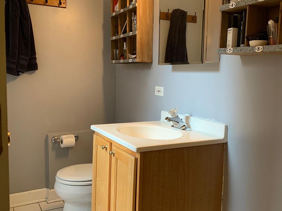 Upper-level full bathroom with bathtub and closet.