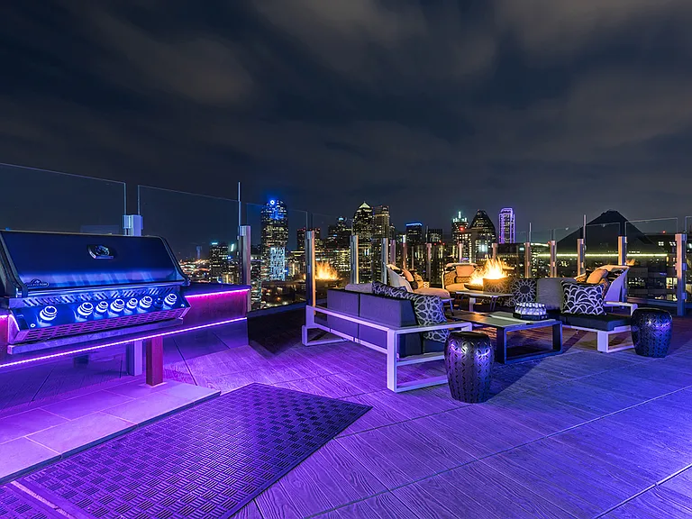 One UptowStunning rooftop pool with city views and lounge seating