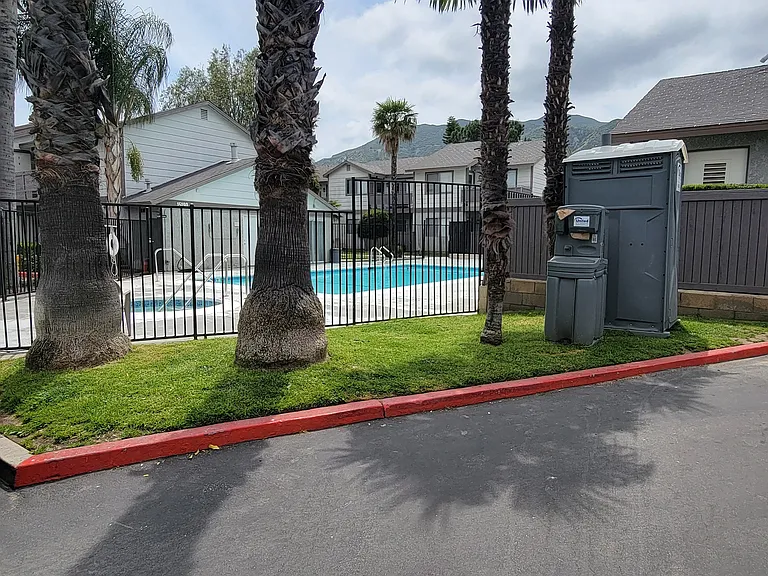 Palm trees around the swimming pool and spa at Grand Oaks Apartments in Lake Elsinore, California.