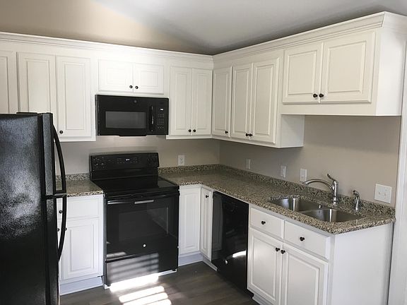 Newly renovated kitchen. All new appliances. Gleaming clean, white custom cabinetry. Granite countertops, dishwasher, dispose-all, smooth cooktop, ice maker, microwave, tons of countertop prep space