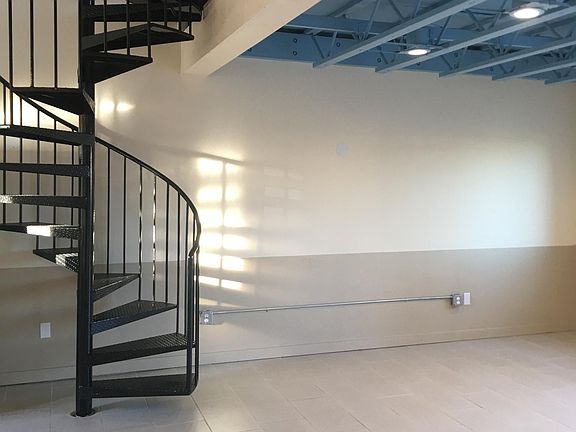 Living room area and spiral stairway