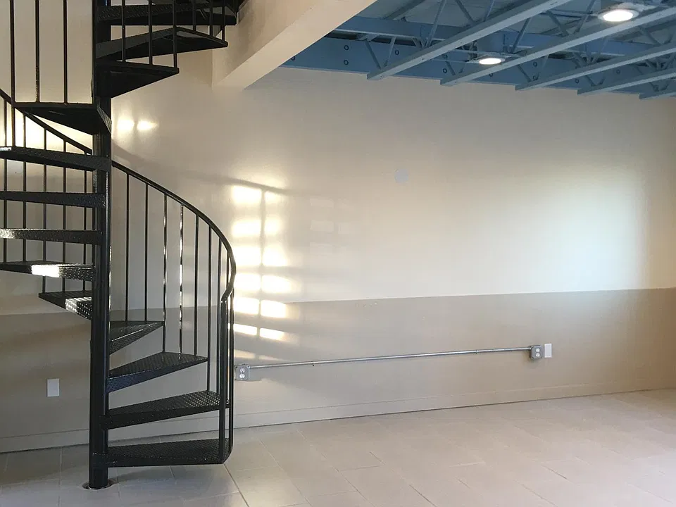 Living room area and spiral stairway