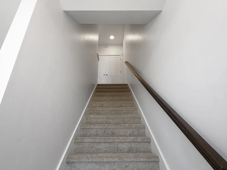 Stairs leading to third floor ft laundry room doors