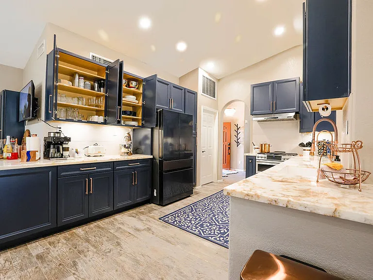 Kitchen with french style refrigerator, service for 8, serving dishes, blender/magic bullet, griddle, air fryer, Ninja coffee center, Kitchen aid mixer, toaster, microwave