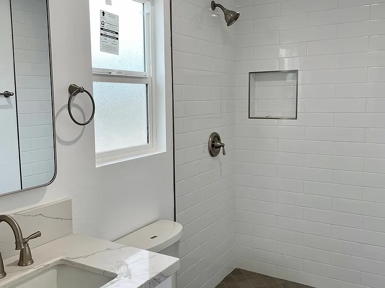Bathroom #1.5 located in hallway / rear unit