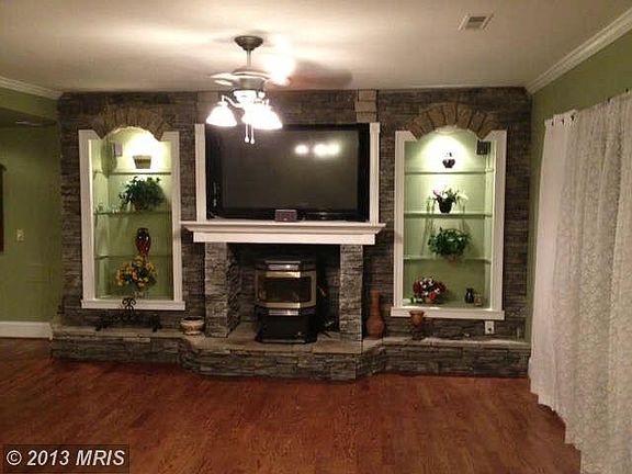 Stone fireplace,pellet stove,shelves and built in  tv shelf