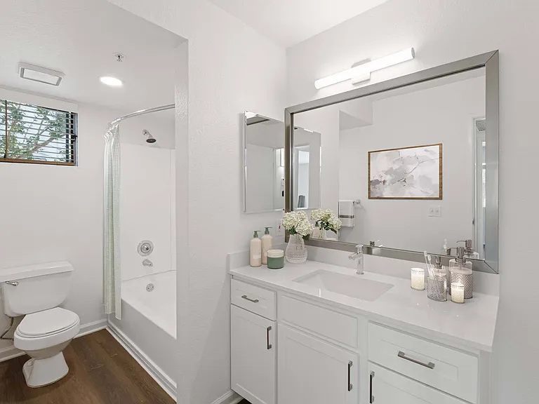 Upgraded bathrooms feature modern appliances and ample storage