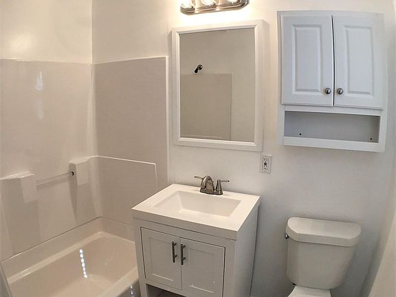 Bath features new tile, vanity, above toilet storage, new to