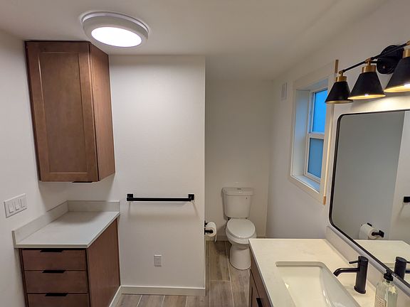 A newly constructed bathroom, showing the amount of storage drawers and upper cabinet, ceiling fan
