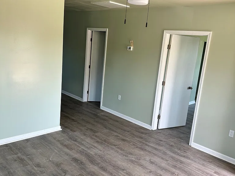 large, lovely living room designed for comfort . With plenty of space to relax. Perfect for hosting friends or enjoying quiet nights in.