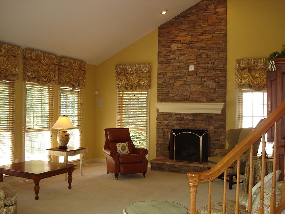 Family room with vaulted ceiling and stone fireplace
