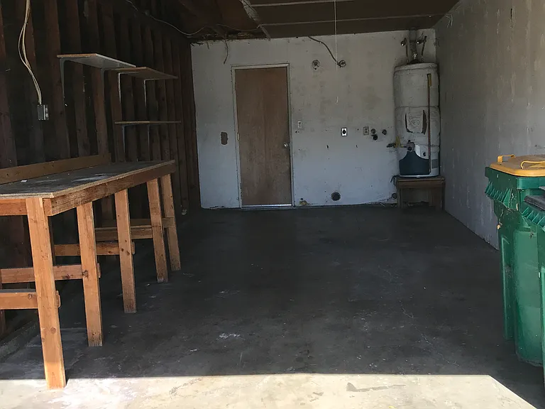 Private attached oversized 1-car garage with (as-is) workbench