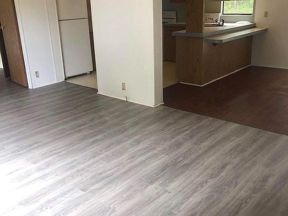 Large spacious living area with large bar and formal dining room! Home offers two backdoors.