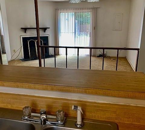 OPEN FLOOR PLAN THRU THE LARGE OPENING FROM THE KIT TO DINING ROOM AND AT THE FAR END THE LIVING ROOM. PATIO DOORS LEAD TO THE BACKYARD.