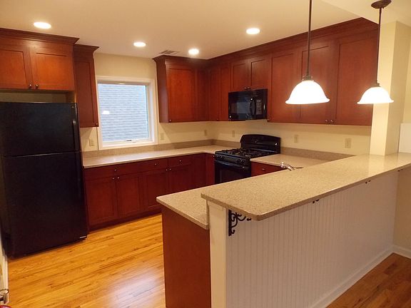 Good sized Kitchen. Plenty of cabinet space. Yes, there is a dishwasher next to sink. Kitchen faucet can be seen. Breakfast Bar or use space for dining table or both.