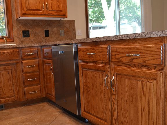 Updated kitchen with stainless-steel appliances and oak cabinetry.