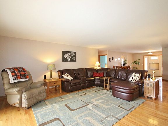 The living room is a great spot for relaxing with plenty of room for a full size sectional and a reclining chair. There is plenty of room for everyone in this massive living room.