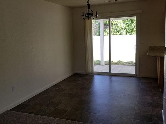 Dining area with eating bar and new slate style vinyl, matte finish to keep safe from slips. Sliding door has new vertical blind