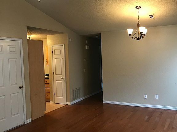 View from living room toward kitchen and hallway to bedrooms/bathroom