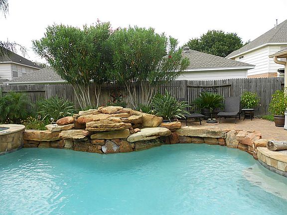 flagstone coping and natural stone water-line tile.