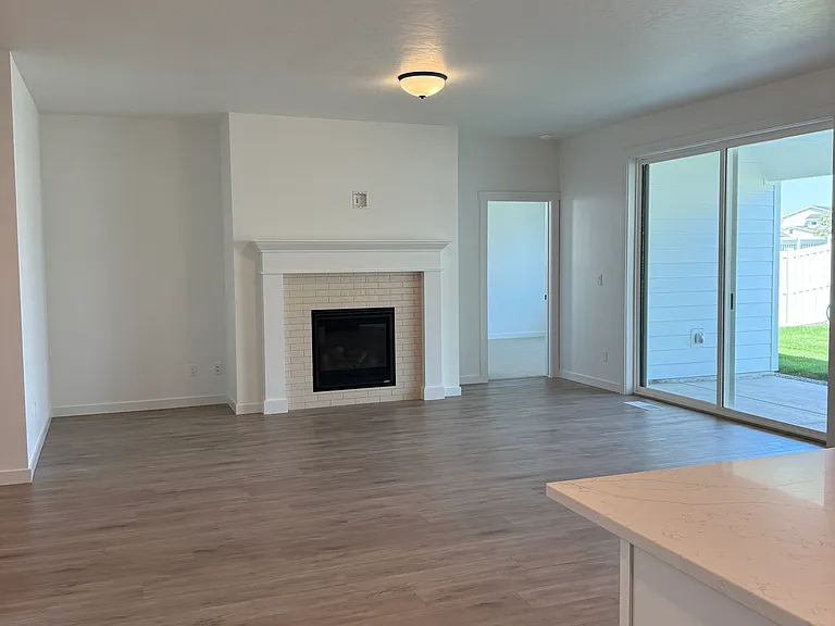 Great room w/ fireplace, nook, large sliding glass door.