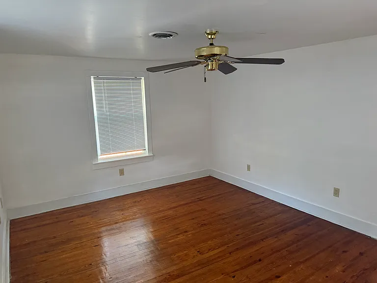 Second floor third bedroom with ceiling fan (back of house)