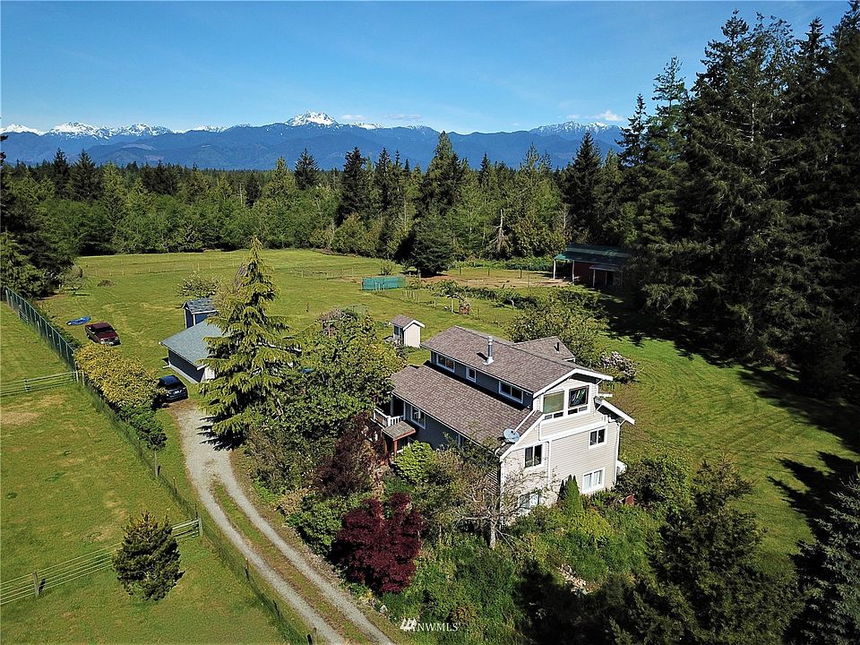  Welcome home with a view of the Olympics, detached double car garage, barn to the right of home next door to outdoor arena, large pasture area, behind the garage is your crafting / hobbies  