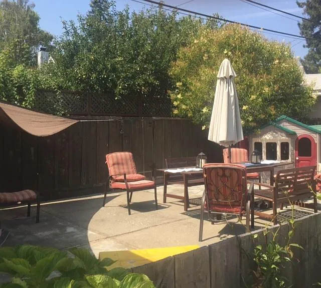 Level fenced patio area with furniture as set up by previous tenants. (No patio furniture is included for the rental.)