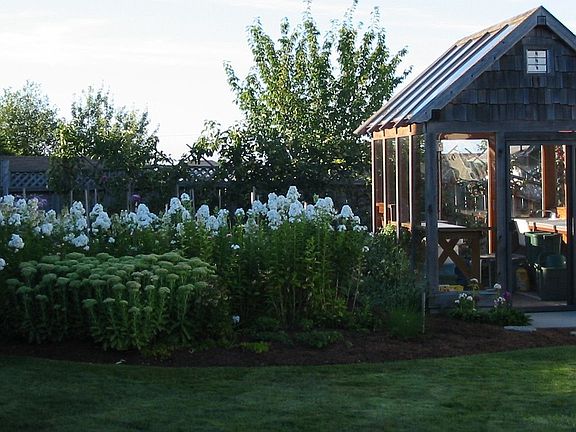 Attractive glass greenhouse with water and power.