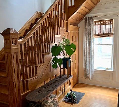 Entryway, original woodwork, and stairs to 2nd floor