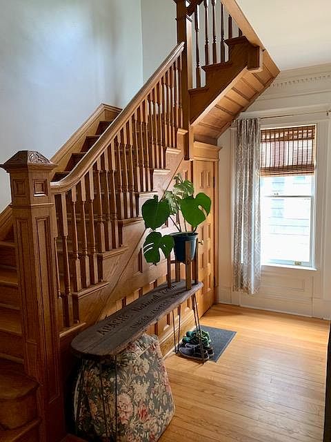 Entryway, original woodwork, and stairs to 2nd floor