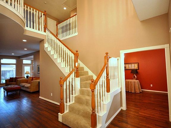 Upon entering the home are the stairs and wood flooring that leads to the family den, formal dining and study.