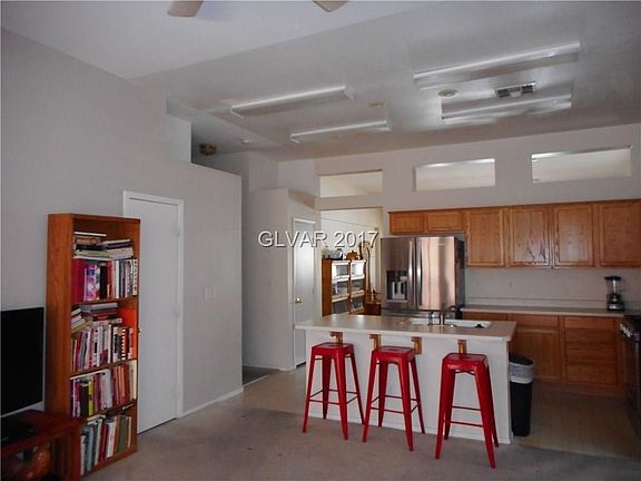 Bright and airy kitchen features breakfast bar at the island. Stainless steel refrigerator, dishwash